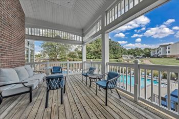 A covered porch with furniture on it